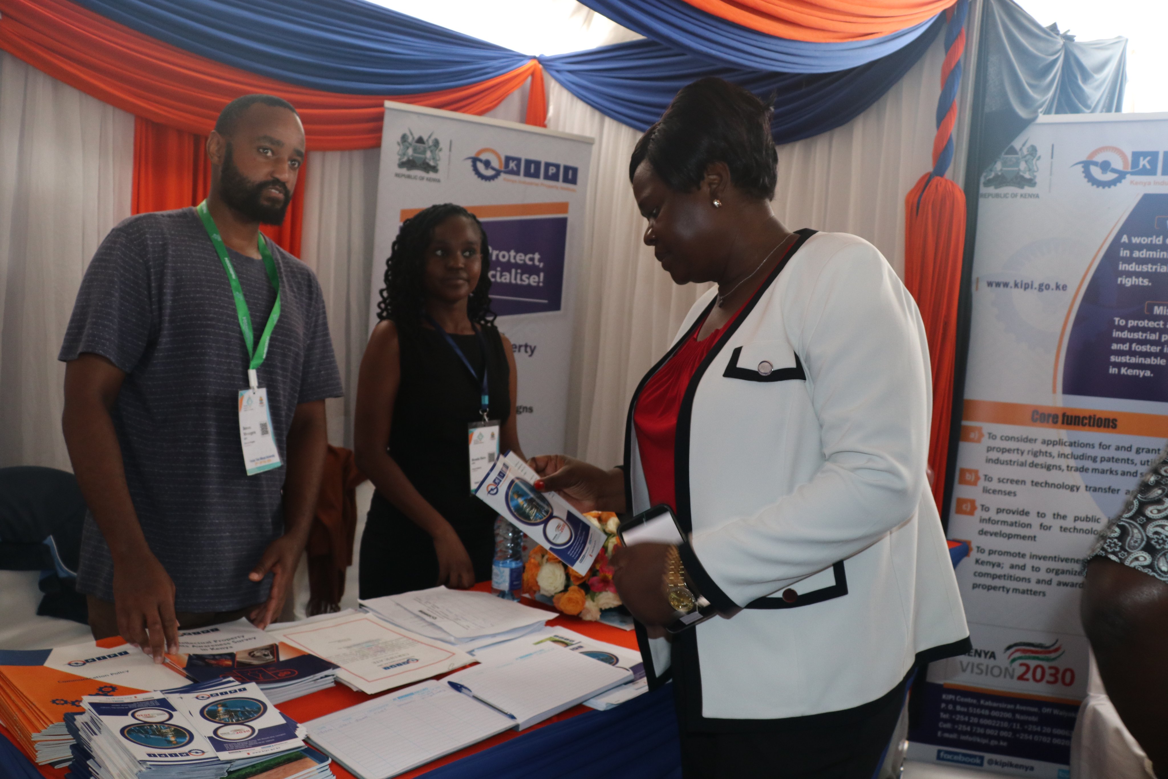 3.	Hon. Gladys Wanga, Governor Homa Bay County, engages Benson Baituru (Left) and Brenda Haro when she toured of the Institute’s Stand during the 2nd Homa Bay International Investment Conference 2024 held at the Tom Mboya University, Homa Bay, from 27th February to 29th February 2024